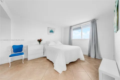 a spacious bedroom with a bed and a table