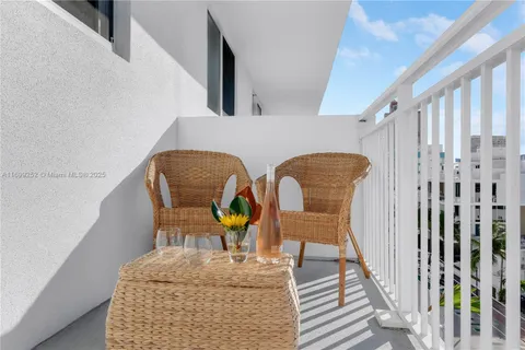 a view of roof deck with two chairs and a table