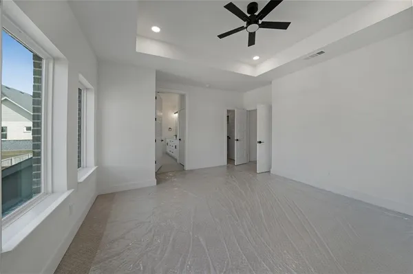a view of a livingroom with a ceiling fan a ceiling fan and windows