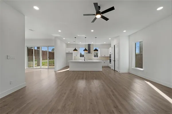 a view of a living room a window and wooden floor