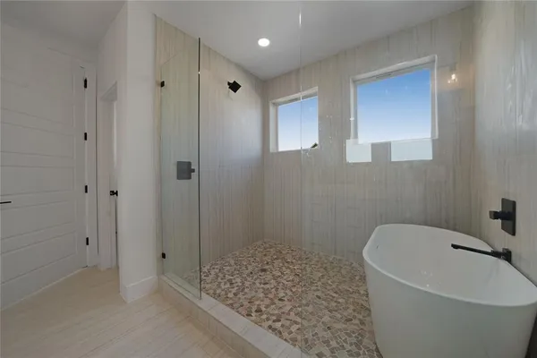 a bathroom with a bathtub and shower