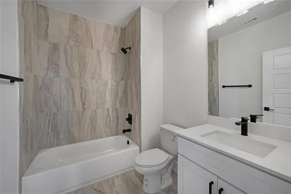 a bathroom with a sink a toilet and a bathtub