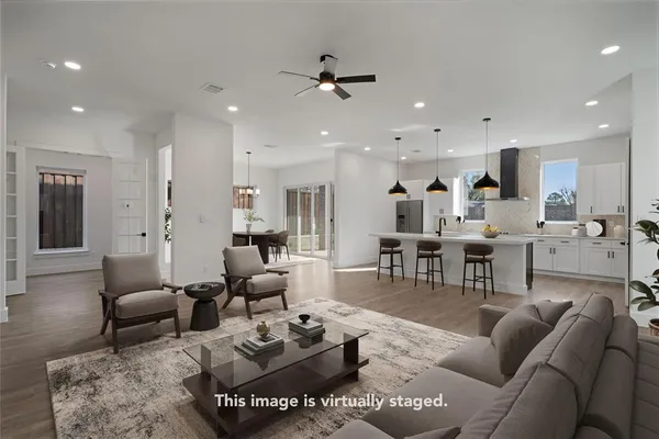 a living room with furniture kitchen view and a table