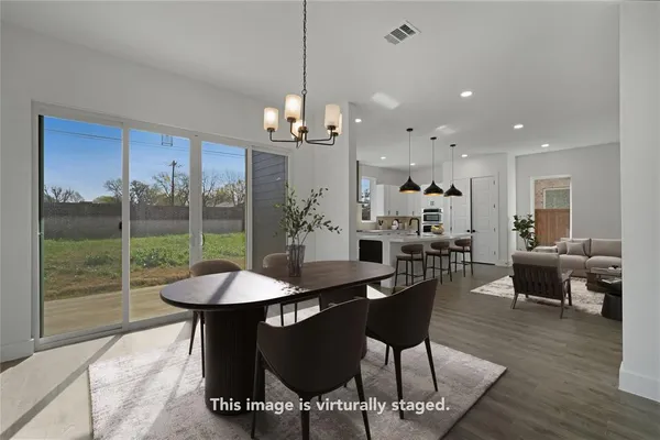 a view of a dining room with furniture window and wooden floor