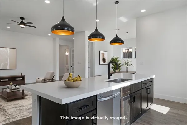 a kitchen with a sink a counter and cabinets