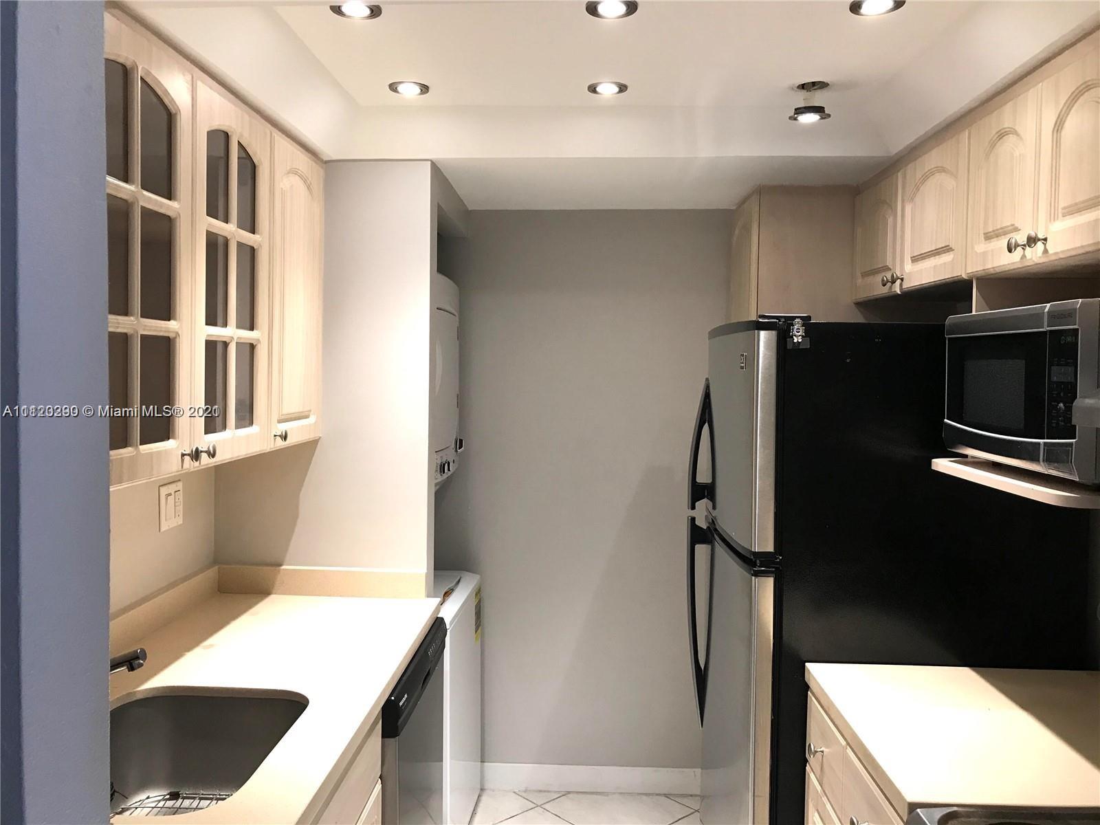 520 Brickell Key Drive, Unit A1717 Miami, FL 33131 - Photo 3 of 6 a kitchen with stainless steel appliances a refrigerator and a stove