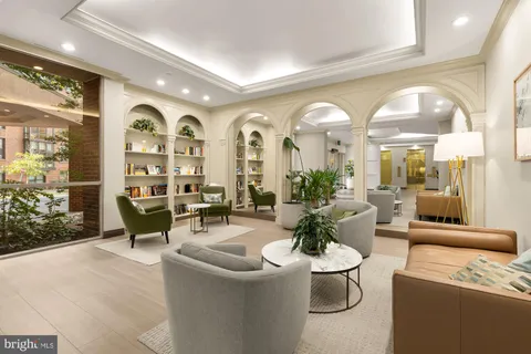 a living room with furniture and a large mirror