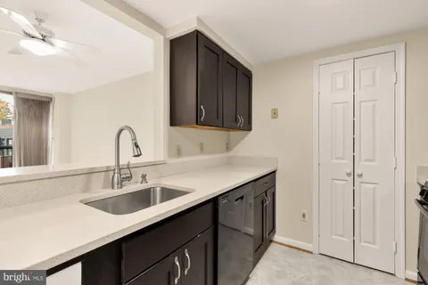 a kitchen with a sink and cabinets