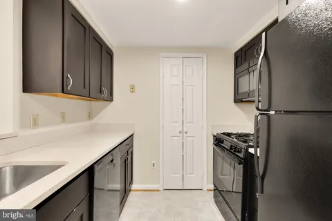 a kitchen with a refrigerator and a sink