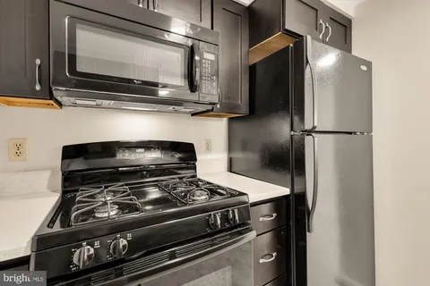 a stove top oven sitting inside of a kitchen