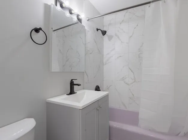 a bathroom with a sink toilet and shower