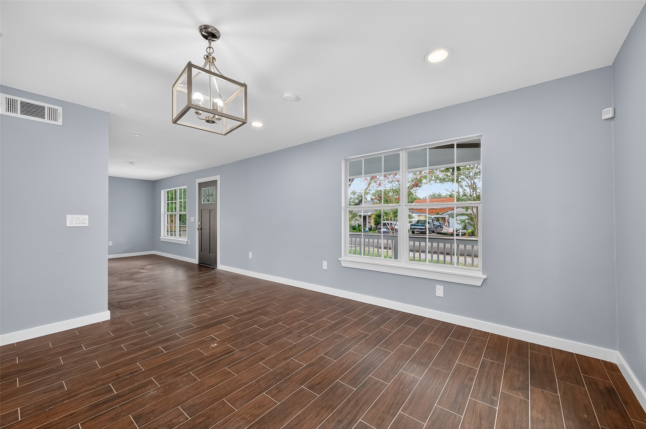 1933 Santa Rosa Street Houston, TX 77023 - Photo 11 of 44 a view of an empty room with wooden floor and a window
