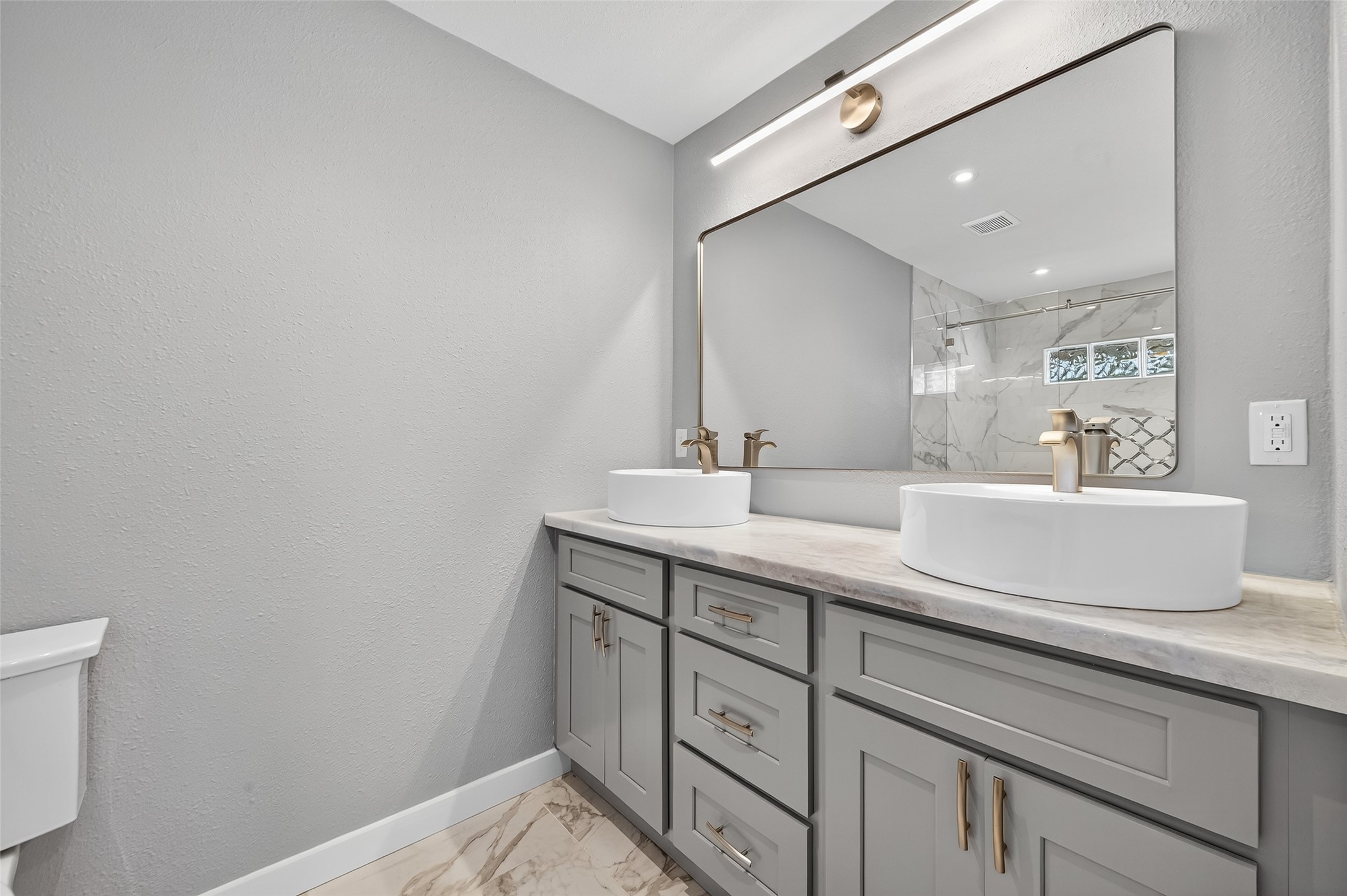 1933 Santa Rosa Street Houston, TX 77023 - Photo 31 of 44 a bathroom with a sink double vanity and a mirror