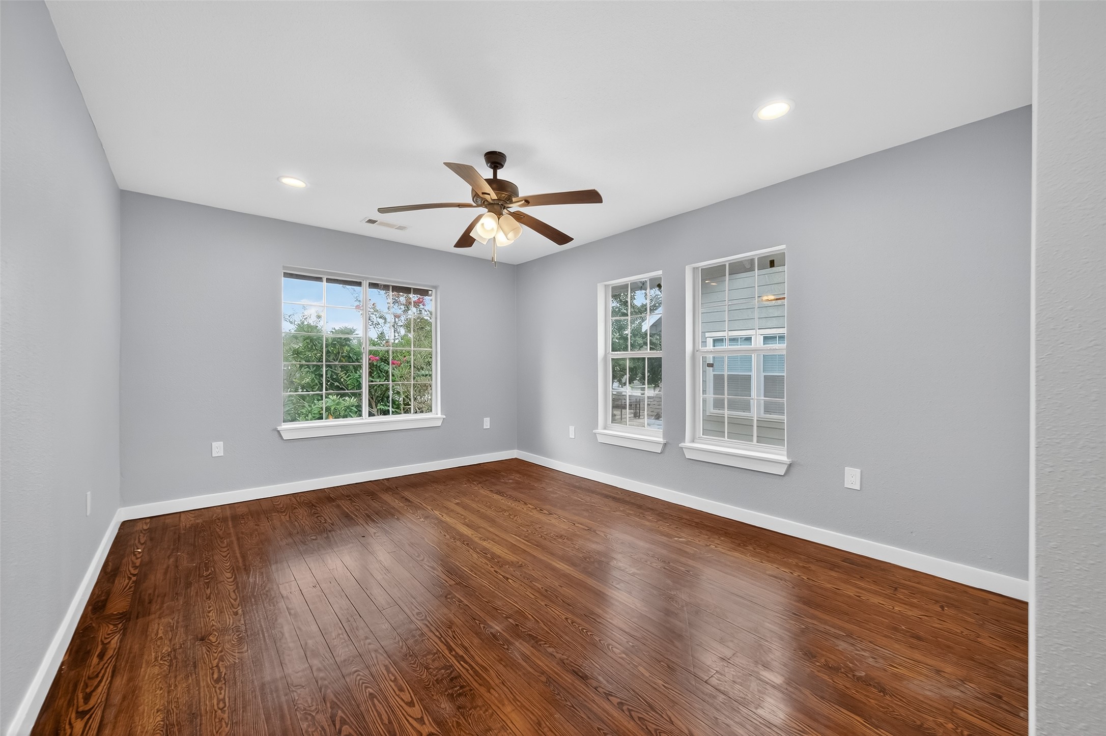 1933 Santa Rosa Street Houston, TX 77023 - Photo 33 of 44 a view of a big room with wooden floor and windows