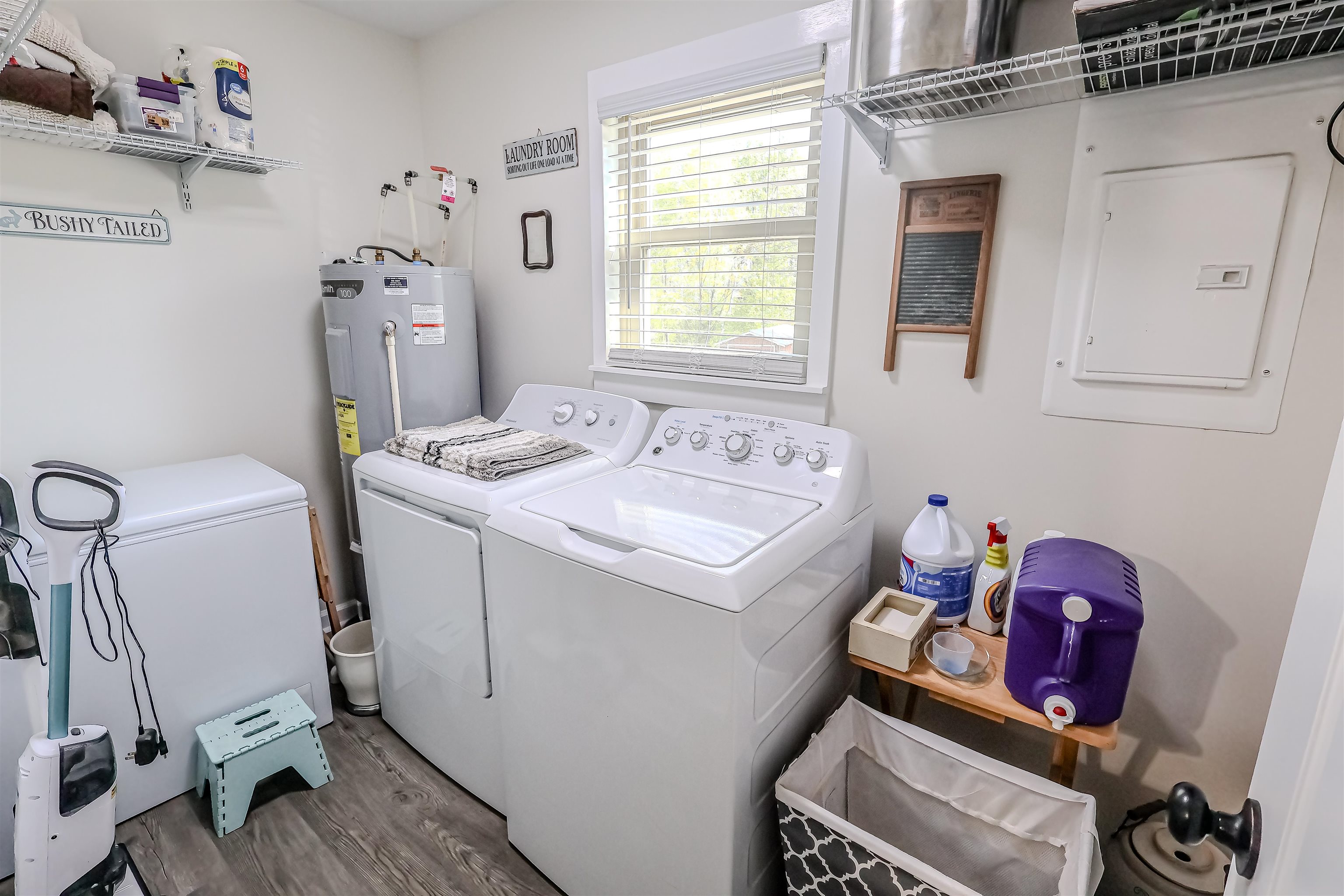 6264 Asbury Glimp Road Ripley, TN 38063 - Photo 12 of 18 Laundry room with washer and dryer, electric panel, laundry area, electric water heater, and wood finished floors