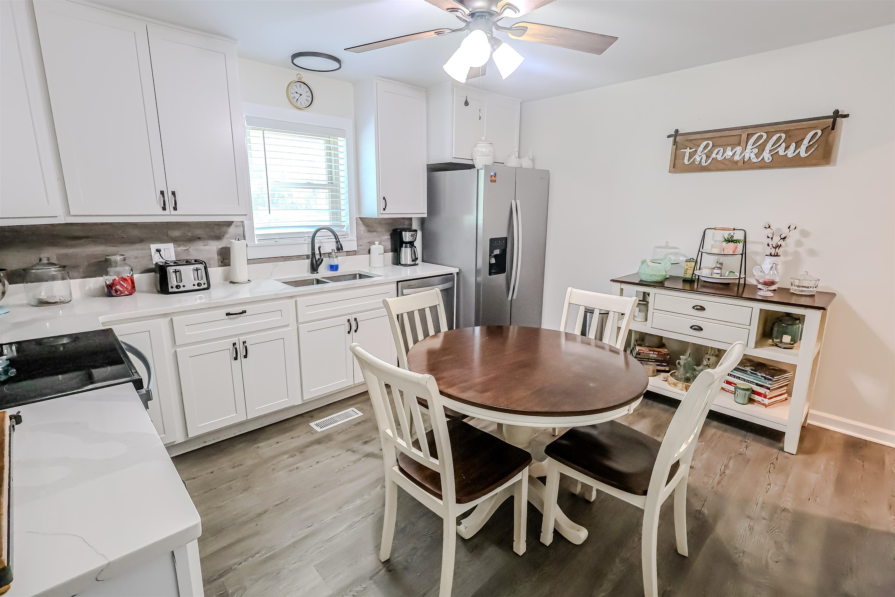6264 Asbury Glimp Road Ripley, TN 38063 - Photo 10 of 18 Kitchen featuring a ceiling fan, white cabinets, visible vents, appliances with stainless steel finishes, and a sink