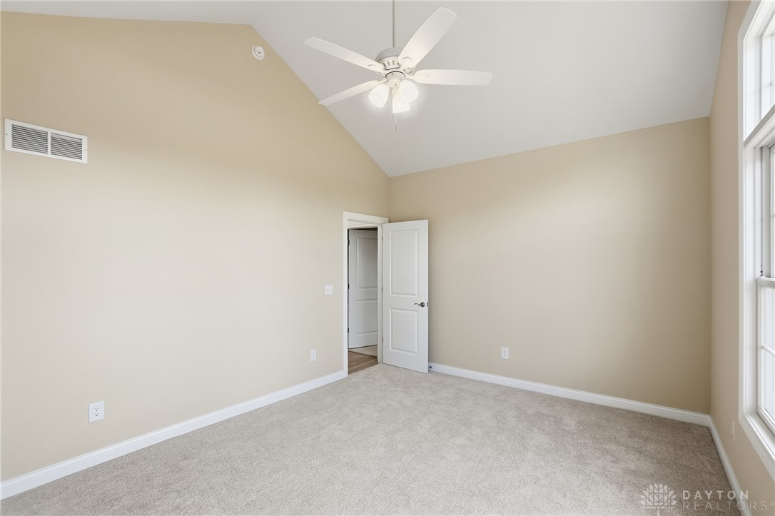 4600 Beal Road Franklin, OH 45005 - Photo 23 of 42 This airy bedroom features a vaulted ceiling, providing a spacious and inviting atmosphere.