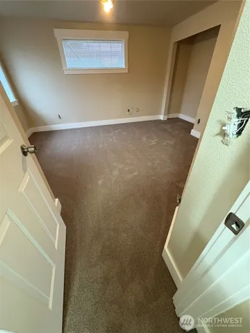 a view of storage and utility room with windows