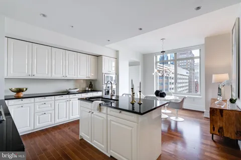 a kitchen with sink refrigerator and cabinets