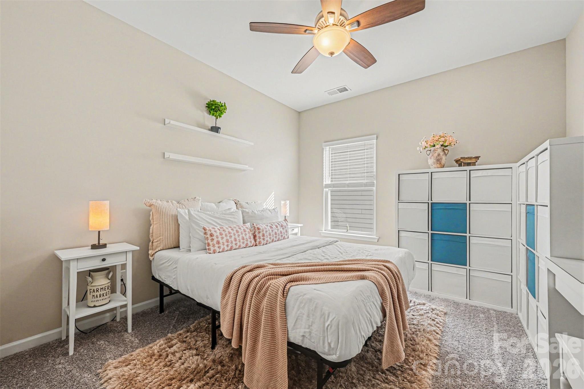 425 Kiser Lane Locust, NC 28097 - Photo 19 of 25 a bedroom with a bed and a chandelier