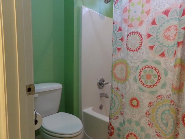 8795 Rowe Gap Road Belvidere, TN 37306 - Photo 22 of 28 a white toilet sitting next to a shower curtain