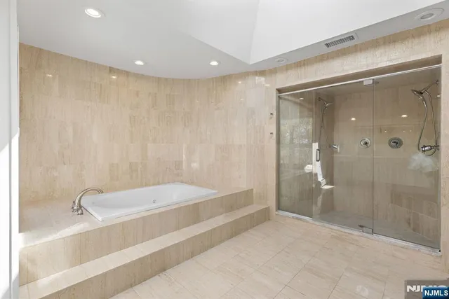 a bathroom with a tub and shower