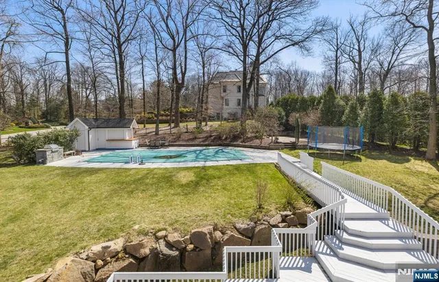 a swimming pool with outdoor seating and yard
