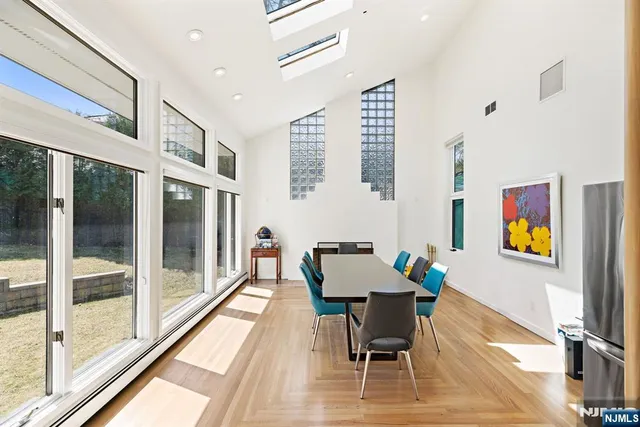 a dining room with furniture and a floor to ceiling window