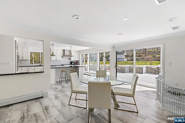 a dining room with furniture and large window