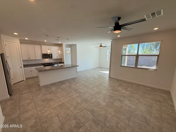 a view of a kitchen with a sink and a refrigerator