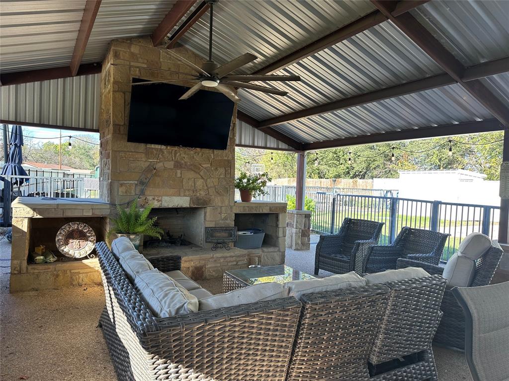 101 Twin Creek Road Comanche, TX 76442 - Photo 8 of 28 Fenced backyard with an outdoor living space, a ceiling fan, and a patio area