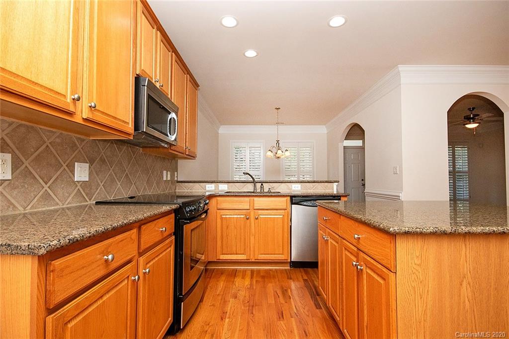 644 Bracket Street, Unit 513 Fort Mill, SC 29708 - Photo 7 of 19 a kitchen with stainless steel appliances granite countertop a sink and cabinets