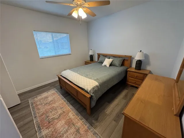 a bed sitting in a bedroom next to a lamp