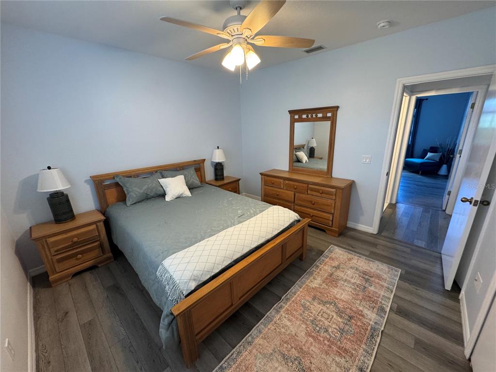 2466 Logsdon Street North Port, FL 34287 - Photo 12 of 18 a bedroom with a bed and wooden floor