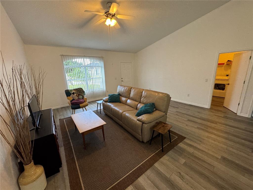 2466 Logsdon Street North Port, FL 34287 - Photo 2 of 18 a living room with furniture and a flat screen tv