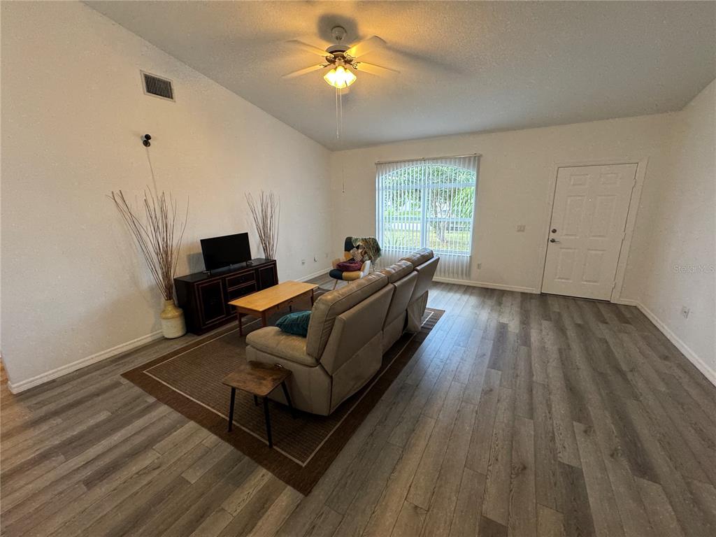 2466 Logsdon Street North Port, FL 34287 - Photo 3 of 18 a living room with furniture and a fireplace