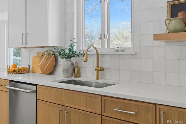 a kitchen with a sink and white cabinets