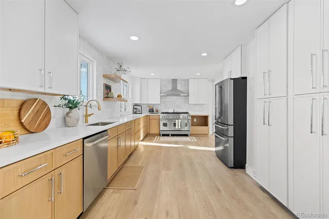 a kitchen with stainless steel appliances a refrigerator sink and cabinets