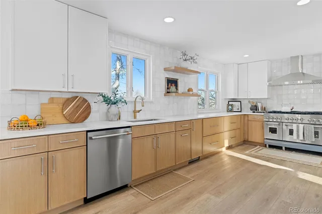 a kitchen with stainless steel appliances granite countertop a sink and cabinets