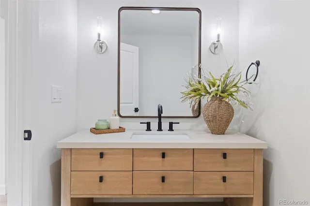 a bathroom with mirror and window