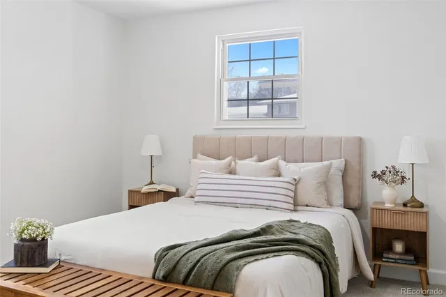 a bedroom with bed and window