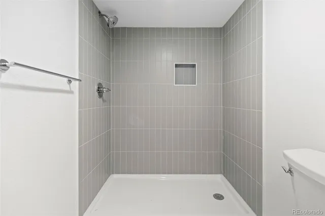 a bathroom with a shower and a toilet