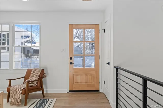 a view of a livingroom with wooden floor and a window