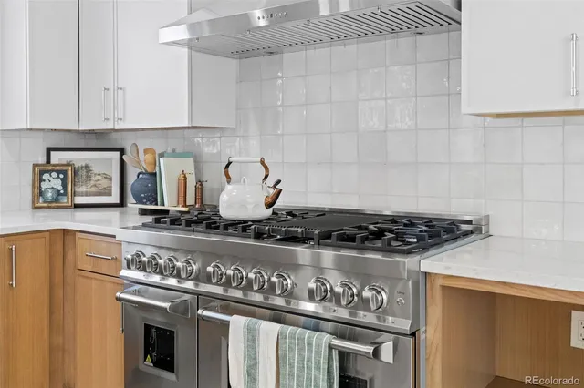 a stove top oven sitting inside of a kitchen