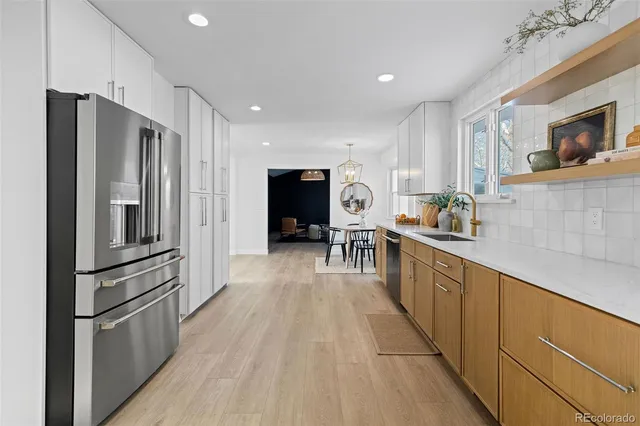 a kitchen with stainless steel appliances a refrigerator and a stove top oven