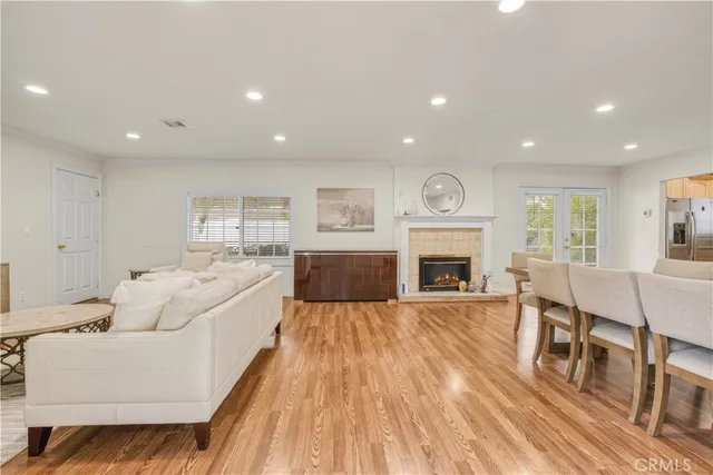 a living room with furniture fireplace and wooden floor