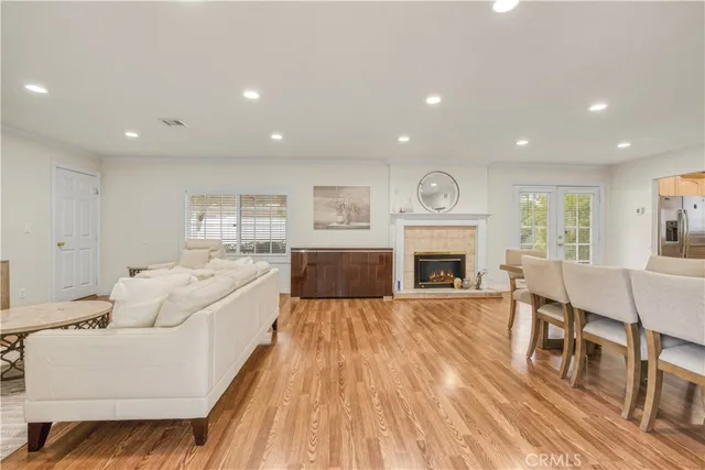 a living room with furniture fireplace and wooden floor
