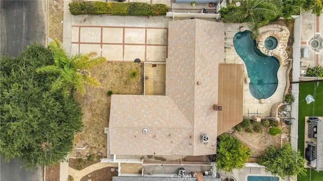 an aerial view of a house with garden space and a fountain
