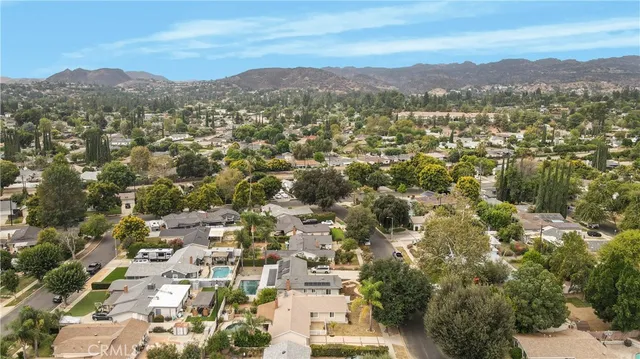 an aerial view of residential houses with city view