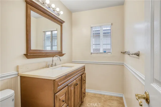 a bathroom with a sink a vanity and a toilet